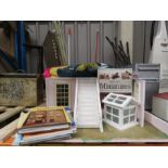 A dolls house base with stairs , greenhouse etc with a group of dolls house decorating books