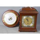 A reproduction mantle clock and wall barometer.
