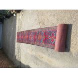 A Middle Eastern stair carpet, red ground.