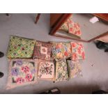 A quantity of needlework cushions, hand made
