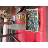 A box of Vintage marbles together with a 1924 Lipton tea caddy and a Bourne bottle with marble