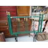 An antique style single bed head and foot in green.