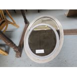 Two oval wall mirrors.