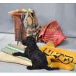 A wicker linen basket, together with a group of vintage rugs, wine rack and carved African