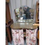 A 1950s dressing table, kidney bean shaped, with three mirrors to the back.