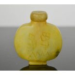 A Chinese hand carved natural jade snuff bottle, floral design, signed