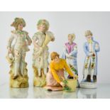 A group of figurines, including a pair of German lady and gentleman figures, 18cm high.
