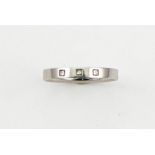 A platinum band, marked 950, set with three princess cut diamonds, size L, 3.2g.