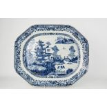 A large early 19th century Chinese blue and white platter, depicting buildings in landscape beside