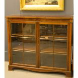 An Edwardian mahogany glazed cabinet, with two doors enclosing two shelves, raised on bracket feet.