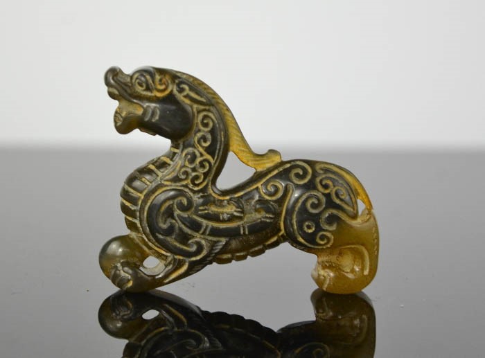 A Chinese natural jade hand carved dragon