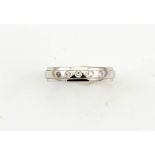 A platinum and diamond band, marked 950, set with five brilliant cut diamonds, size N 4.6g.