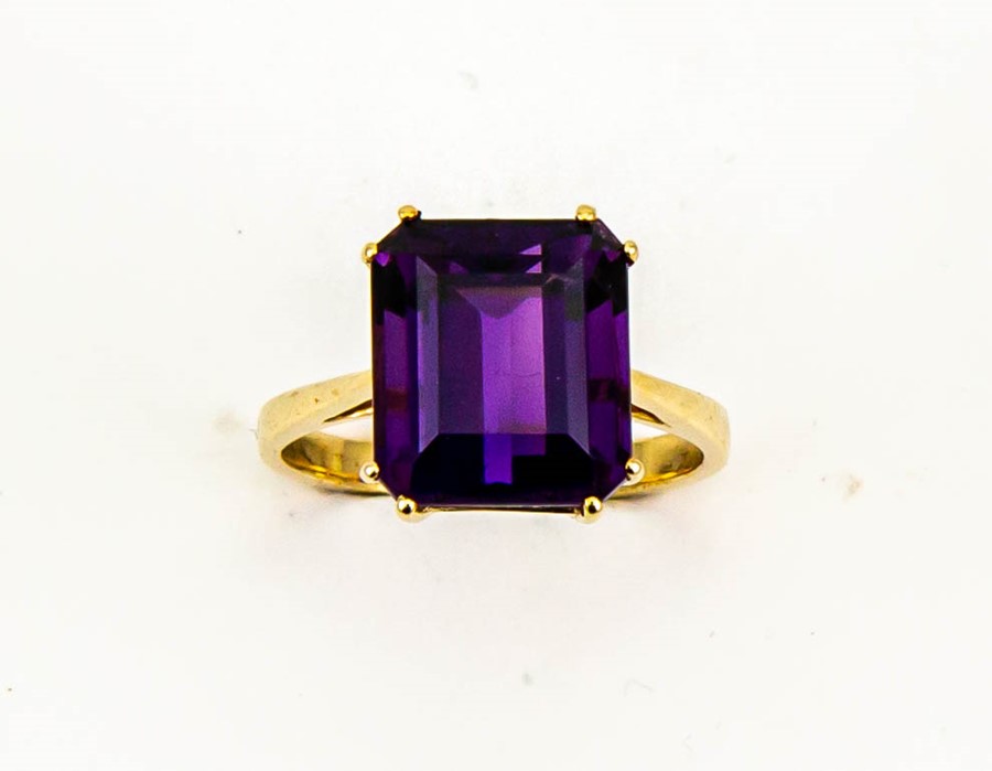 A 9ct gold and amethyst solitaire cocktail ring, the emerald cut amethyst, approx 6cts, size O, 4.