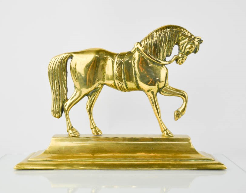 A Victorian brass door stop in the form of a horse,