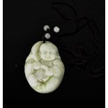 A Chinese hand carved natural jade Buddha pendant, with cord and jade beads