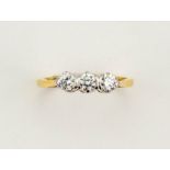 An 18ct yellow gold three stone diamond trilogy ring, size L, 2.8g.