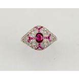 An 18ct white gold (tested, unhallmarked), ruby and diamond Art Deco style ring, size M½, 5g.