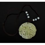 A Chinese natural ice jade hand carved piercework pendant, of two phoenix, with cord and jade beads