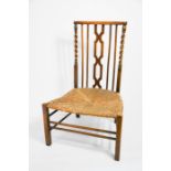 A 1930s prayer chair in oak, with rush seat and barleytwist supports.