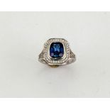 An 18ct white gold, sapphire and diamond ring, the cushion cut sapphire approximately 2.99ct, the