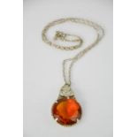 A vintage Scottish large Cairngorm style pendant, amber glass inset