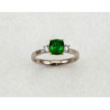 An 18ct white gold, emerald and diamond ring, the emerald approximately 1.30ct, the two flanking