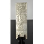 A Tibetan Miao silver scroll weight depicting scholar reading in garden, signed and stamped 180gm