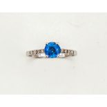 A 14ct white gold ceylon sapphire, approximately 1.20ct, with diamond set shoulders, size M, 1.8g.