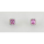 An 18ct white gold, pink sapphire and diamond earrings, the emerald cut sapphires approx 0.50ct,