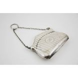 A silver purse, with machine engraved decoration and monogram to the centre, Birmingham 1911,