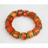 A vintage amber and natural green jade elasticated bracelet