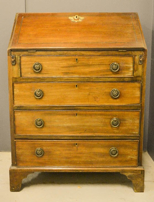 A small 19th century mahogany bureau, the fall front enclosing a fitted interior, above four long