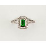 An 18ct white gold tsavorite garnet and diamond Art Deco style ring, size N, 3.9g.