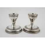 A pair of silver candlesticks, weighted bases, Birmingham 1973, 7cm high.