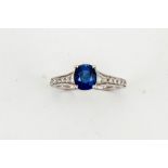 An 18ct white gold, sapphire and diamond ring, the cushion cut sapphire approx 1.60ct, with