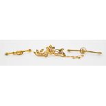 A 9ct gold and seed pearl flowerhead brooch, 3.1g, with safety chain, and two rolled gold tie pins.
