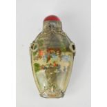 A Chinese reverse painted snuff bottle, depicting a village scene, signed, with Miao silver mounts