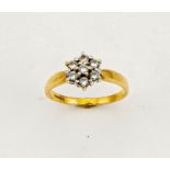 An 18ct gold and diamond cluster / flower head form ring, the diamonds totalling approx 0.50ct, size