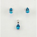 A pair of 18ct white gold and blue topaz earrings, with matching pendant, set with pear cut topaz,
