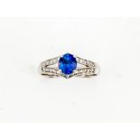 A 14ct white gold, sapphire and diamond ring, the oval sapphire approx 1.10ct, diamonds set in a