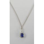 An 18ct white gold, blue sapphire and diamond pendant, the pear cut sapphire approximately 1.06ct,