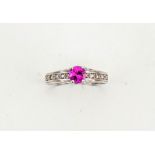 A 14ct white gold and pink sapphire solitaire ring, approx 0.5ct, the shoulders set with diamonds,