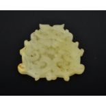 A Chinese hand carved natural jade dragon pendant. 7cm by 7.5cm