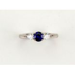 An 18ct white gold and sapphire ring, the brilliant cut sapphire, 0.50cts, with pear shape diamond