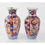 A pair of 19th century Chinese vases, in blue, red and white, 21cm high.