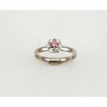 A platinum, pink and white diamond ring, flowerhead form, the pink diamond to the centre 0.12ct, and