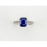 A platinum, sapphire and diamond ring, the emerald cut sapphire approx 1ct, with diamonds set to the