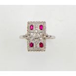 An 18ct white gold Art Deco style diamond and ruby ring, size O, 3.17g.