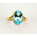 An 18ct yellow gold and aquamarine solitaire cocktail ring, the oval cut aquamarine approx 5.5cts,