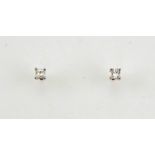 A pair of 18ct gold and diamond solitaire earrings, the princess cut diamonds in white gold claw
